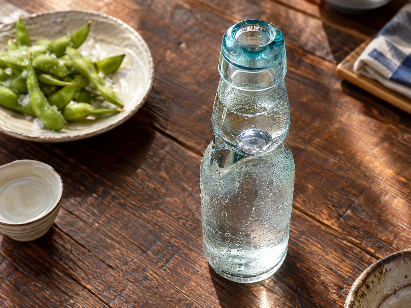 Illustration of unlabelled transparent ramune marble neck bottle condensation with clear soda