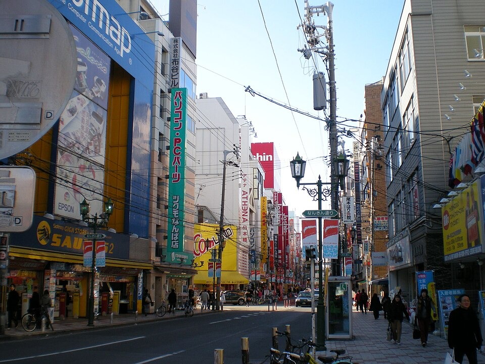 Pedestrians and shop signs on a busy street in Den Den Town near Ebisucho