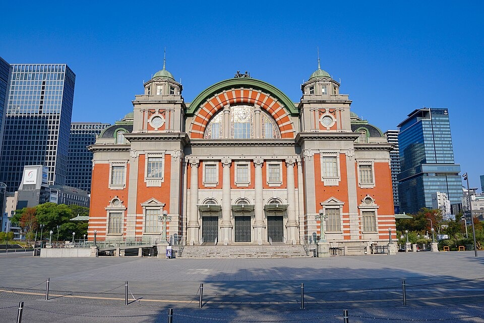 The red-brick Osaka City Central Public Hall beneath a clear blue sky