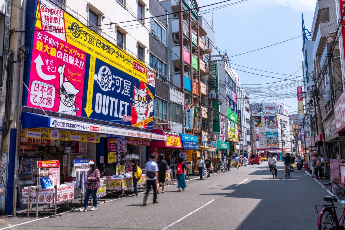 Pedestrians and colorful hobby-shop signs along Ota Road