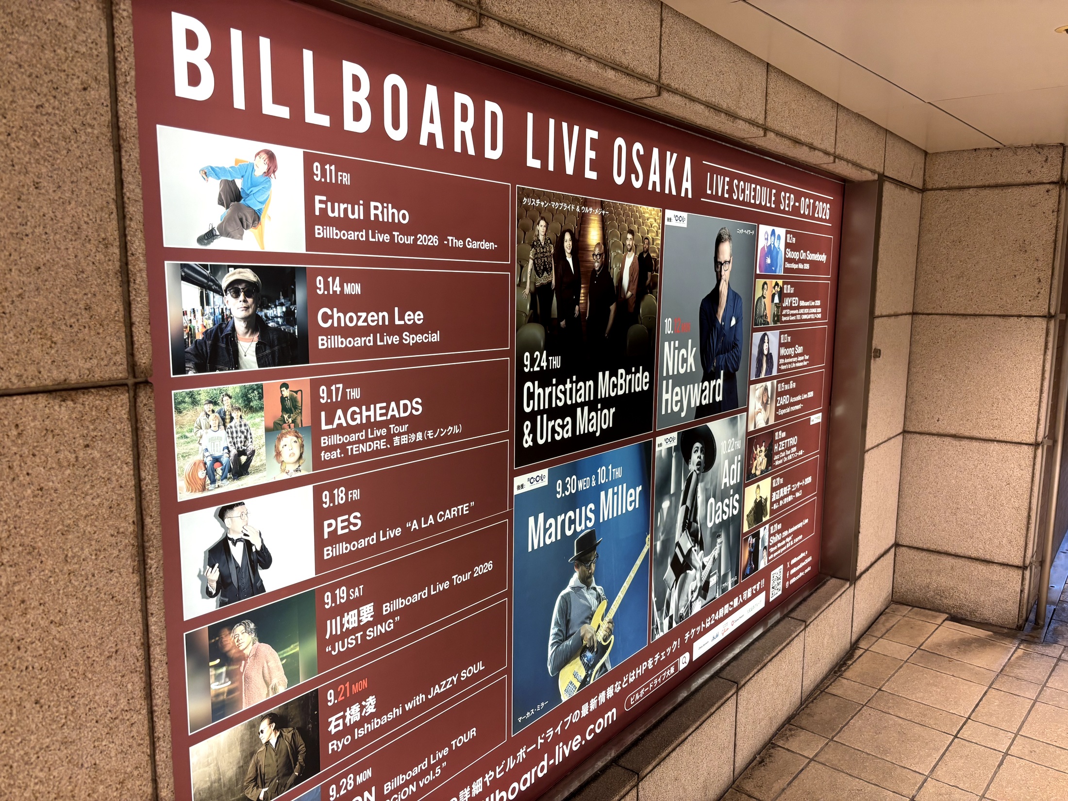 An illuminated Billboard Live OSAKA concert poster display in an underground passage