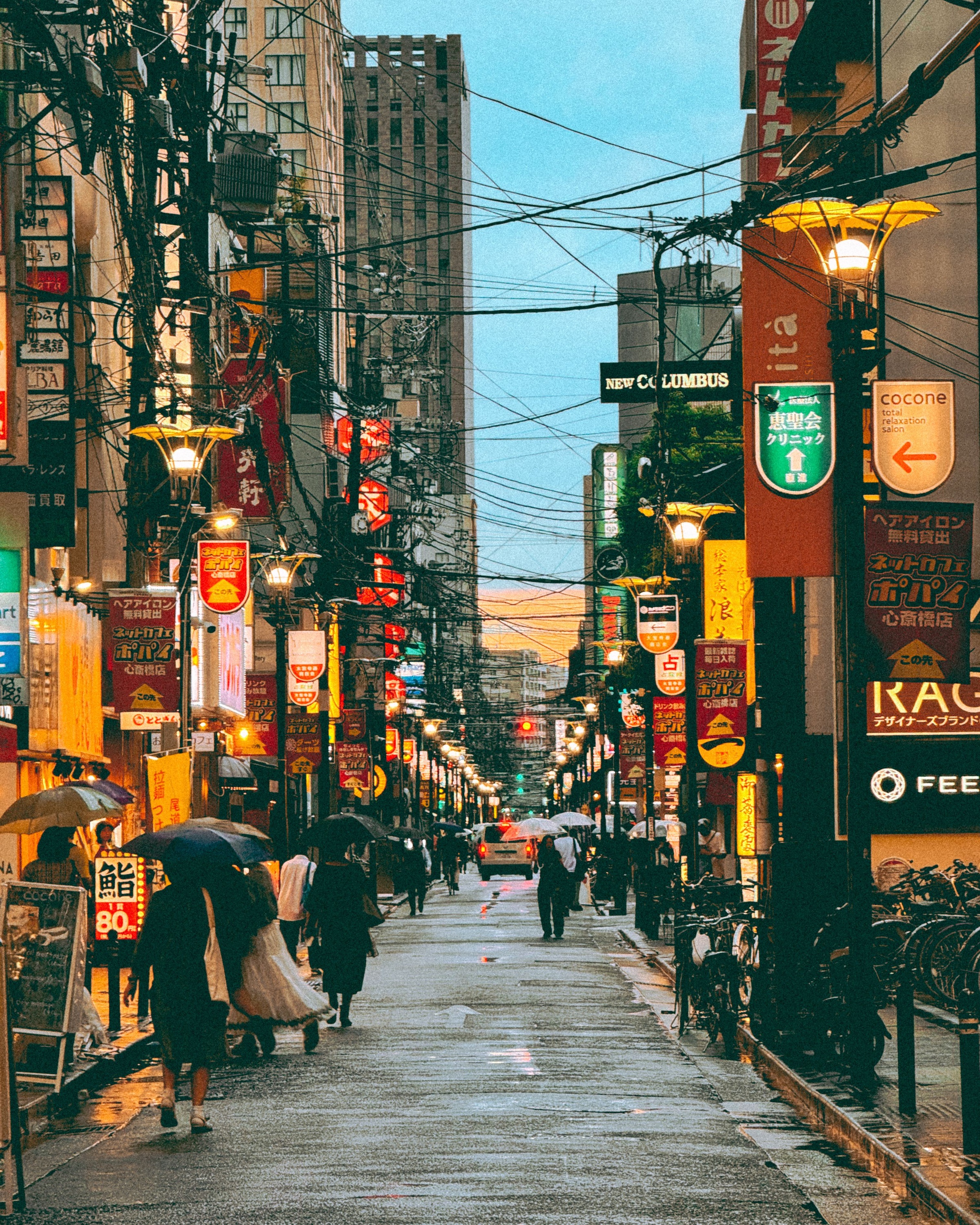 Pedestrians and restaurant signs along a Shinsaibashi side street