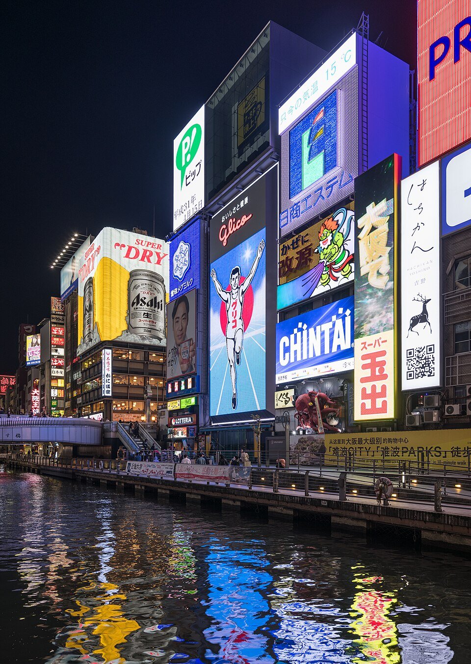 Bright neon signs including the Glico runner beside Dotonbori Canal