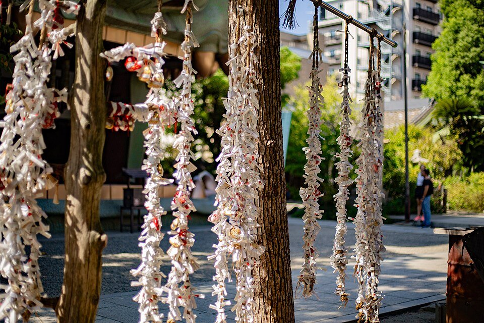 Omikuji fortune slips tied at Namba Yasaka Shrine