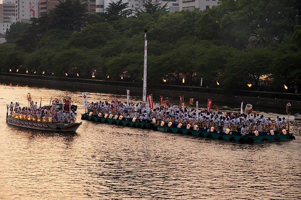 Festival boats carrying participants along the Okawa River at Tenjin Matsuri