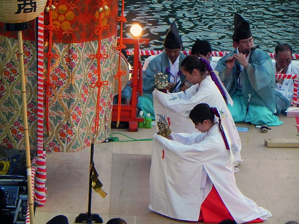 A shrine maiden performing kagura during the Tenjin Matsuri celebrations