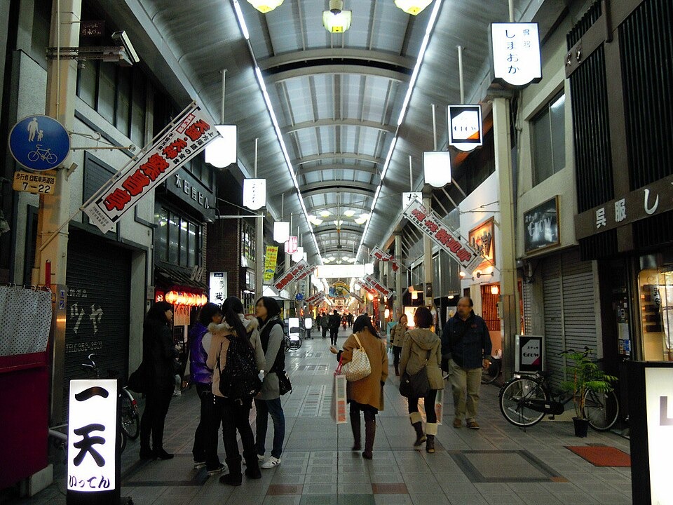 People browsing small shops in the covered Tenjinbashisuji arcade