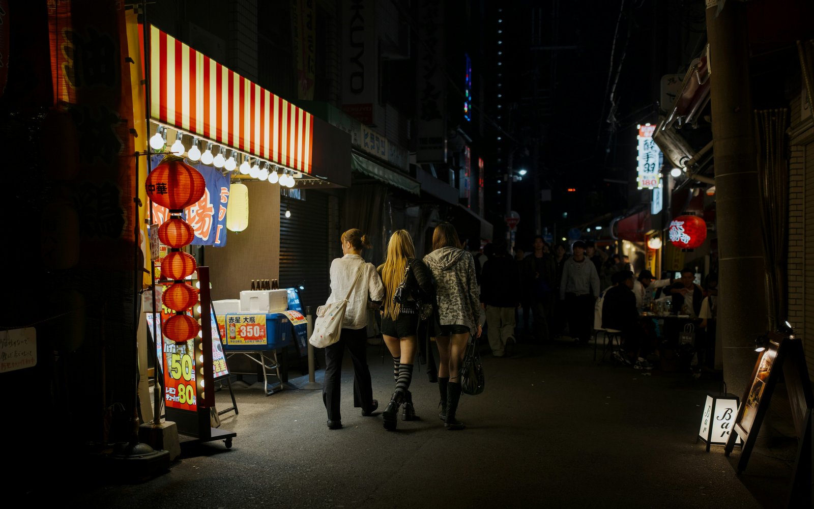 A lively restaurant lane in Tenma after dark