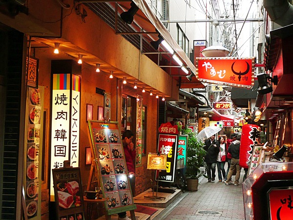 Yakiniku restaurants and illuminated signs along a narrow Tsuruhashi lane